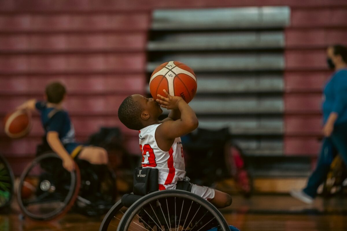 Boys playing basketball in wheelchairs