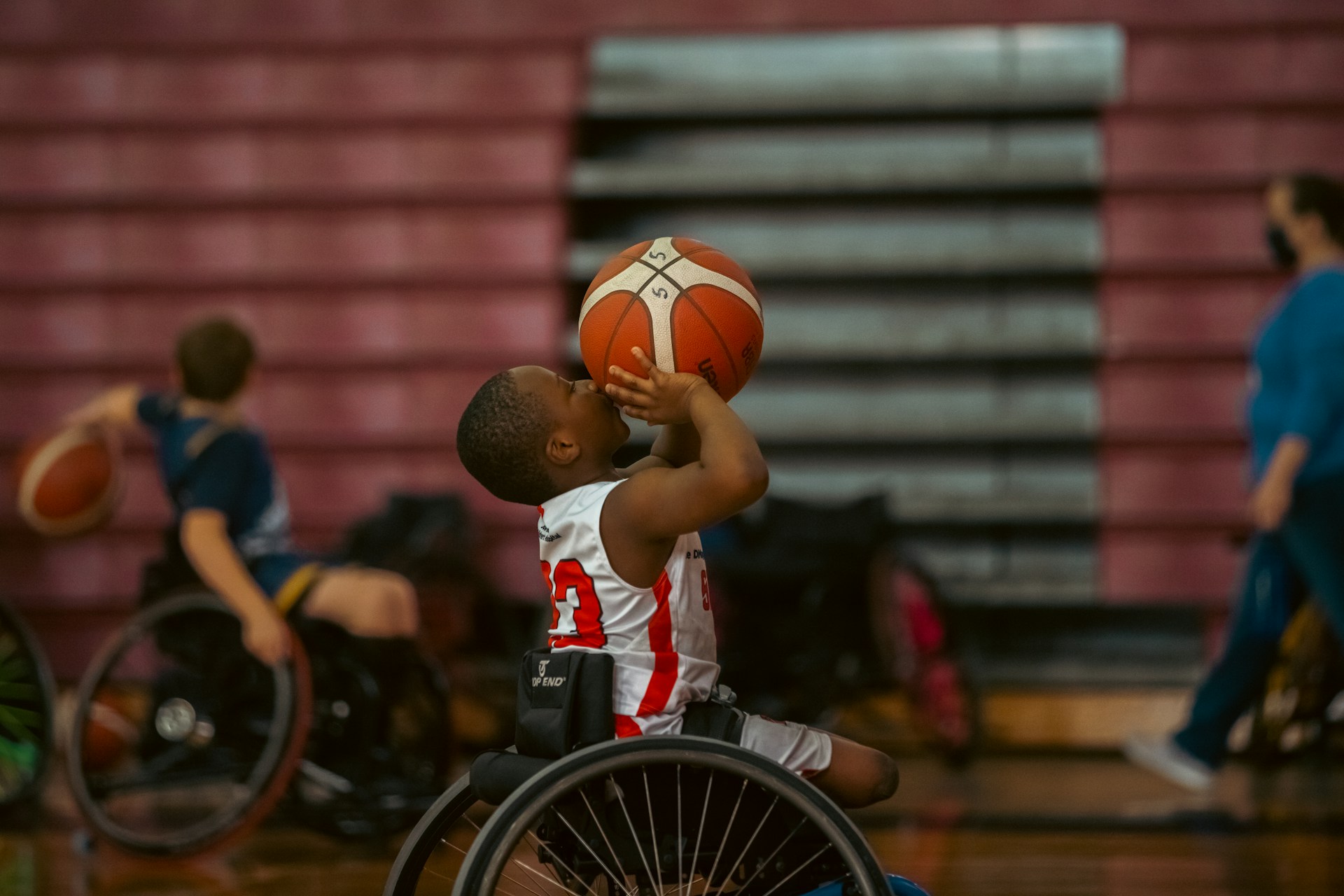 Boys playing basketball in wheelchairs